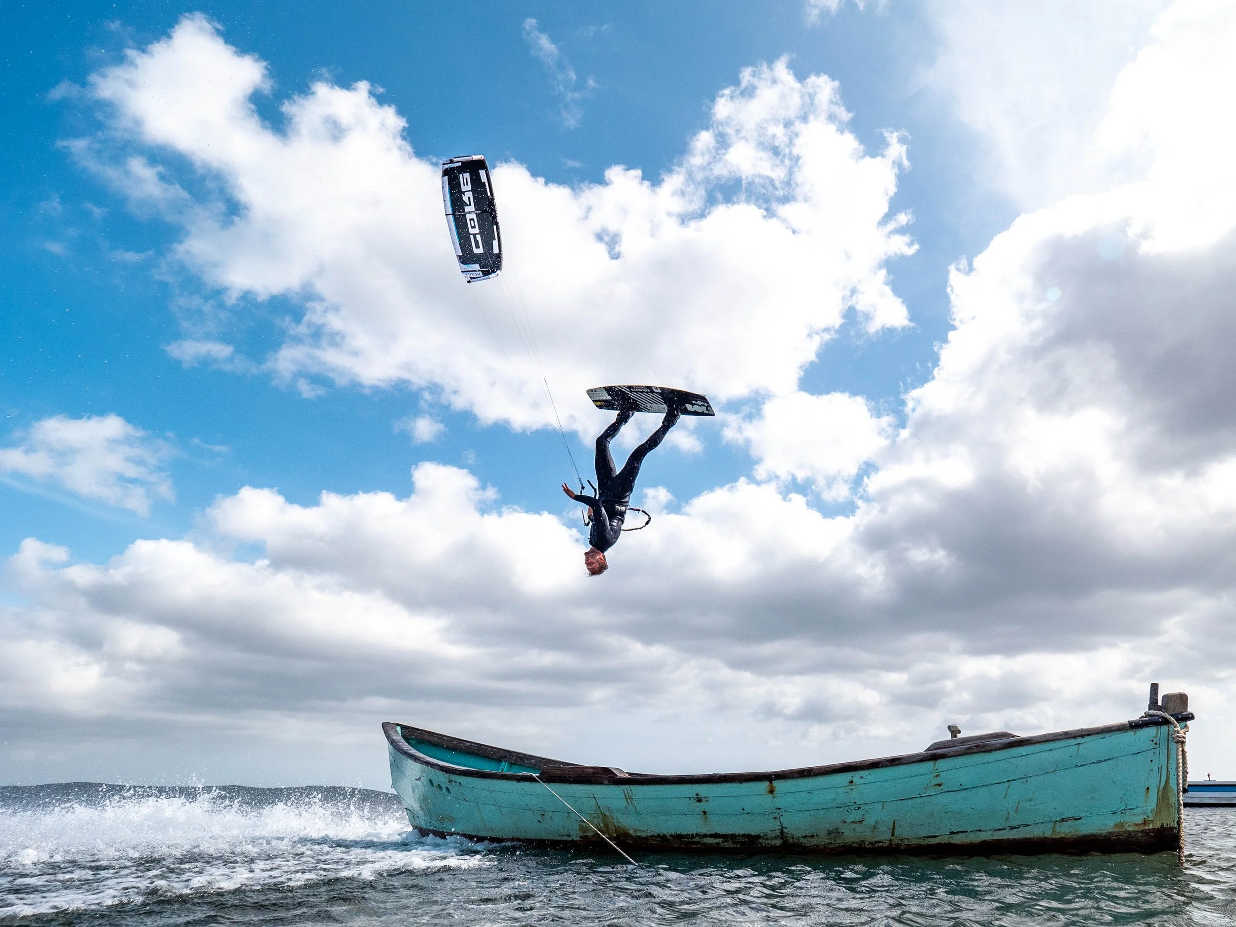 Ben Beholz performing a kiteloop over a boat